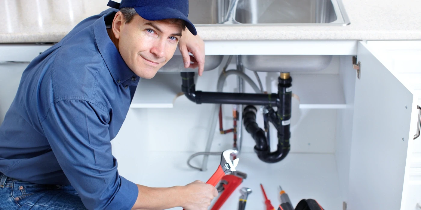 a plumber technician with a tool belt from TMK Plumber Austin in Austin, TX - Sewer backup solutions a plumber technician with a tool belt from TMK Plumber Austin in Austin, TX - Sewer backup solutions